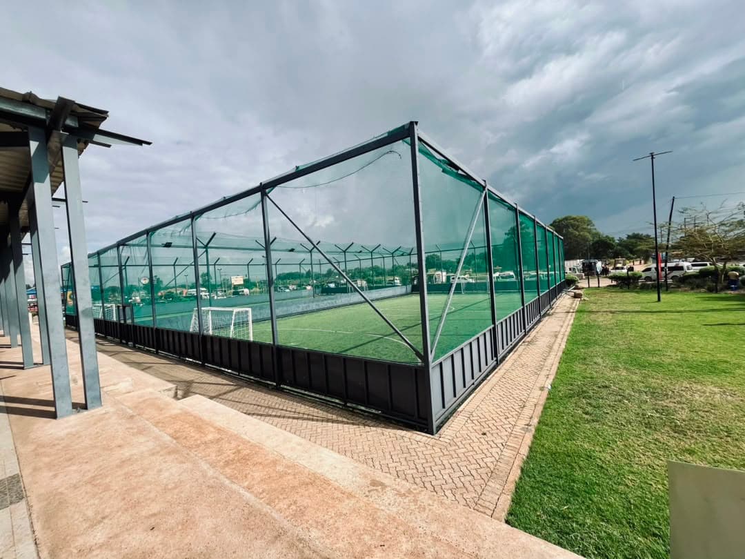 Madfutsal caged artificial pitch at Madokero Mall under a wide sky